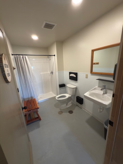 Clean ADA restroom and shower with bench