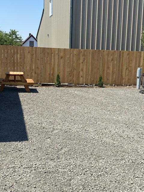 Back-in RV site with picnic table along the fence