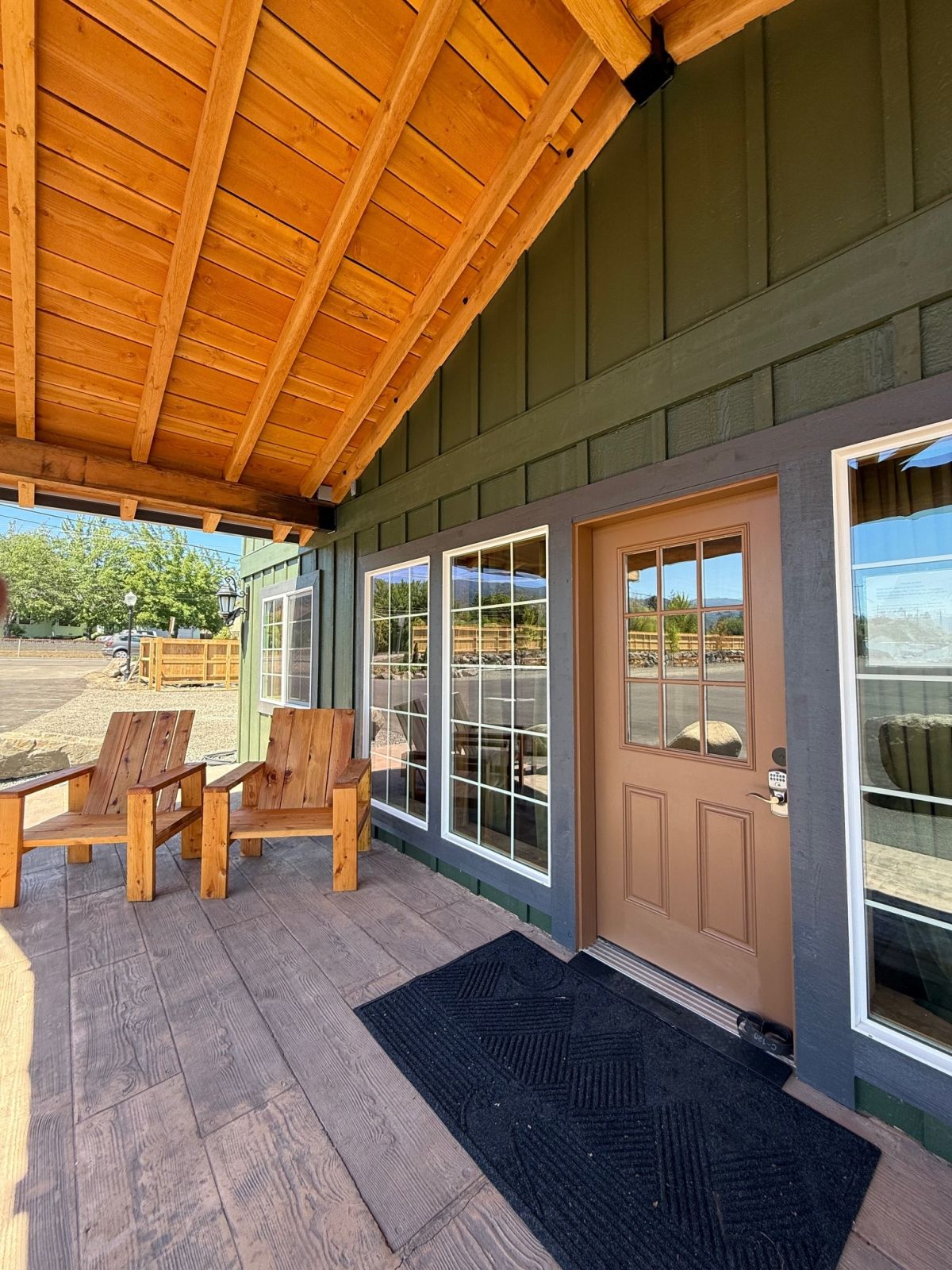 Covered lodge porch with Adirondack chairs